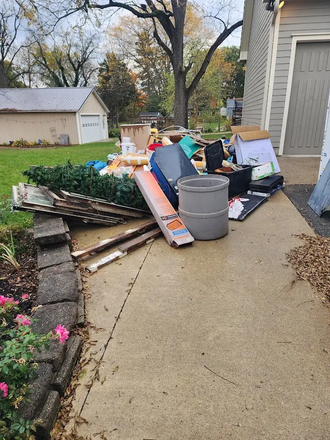 Dumpster being loaded with debris for Estate Cleanout Dumpster Rental in Park